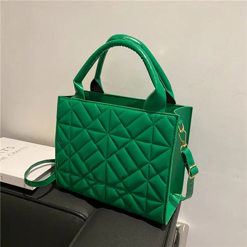 a green purse sitting on top of a table