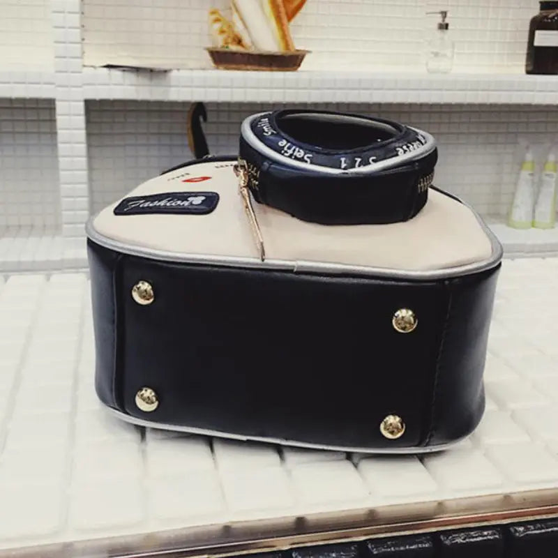 a black and white suitcase sitting on top of a counter