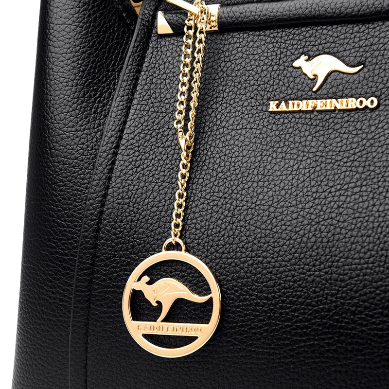 a black handbag with a gold kangaroo charm