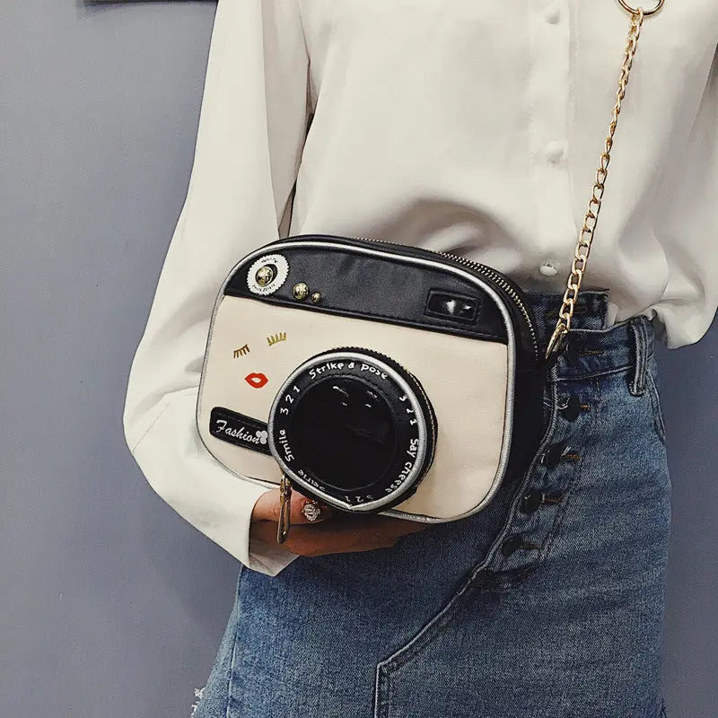 a woman is holding a camera in her hand