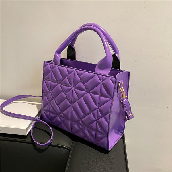 a purple purse sitting on top of a table