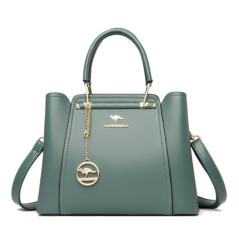 a green handbag with a gold handle
