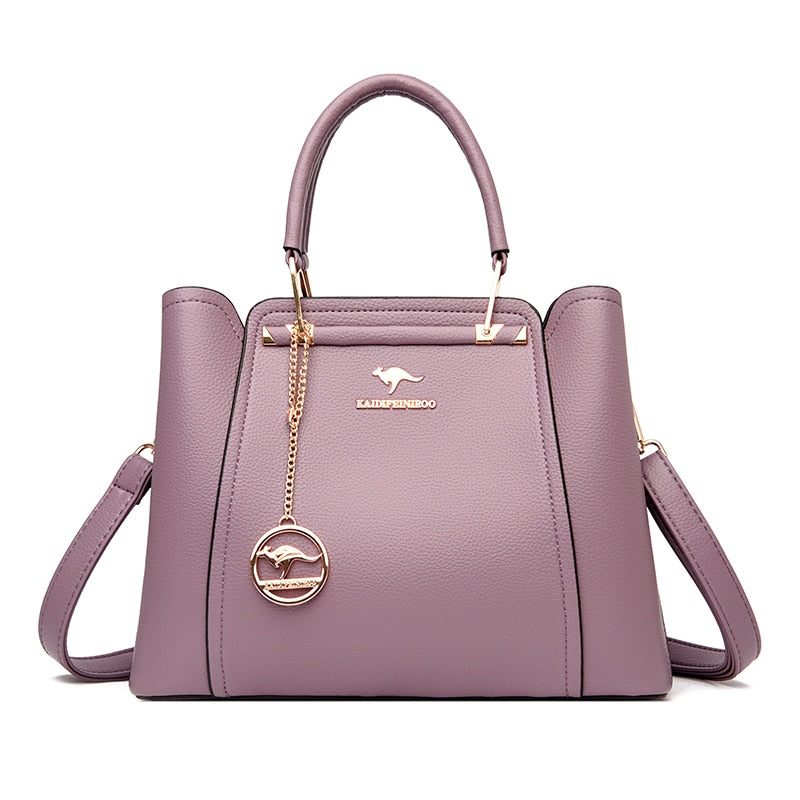 a purple handbag with a gold handle