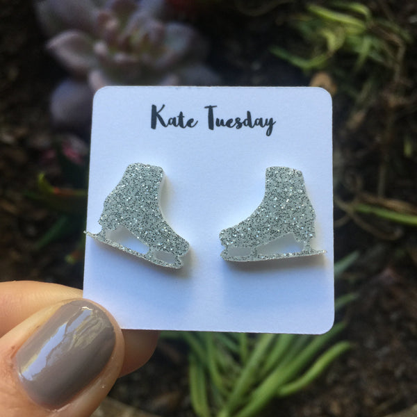 a pair of silver glittered shoes earrings