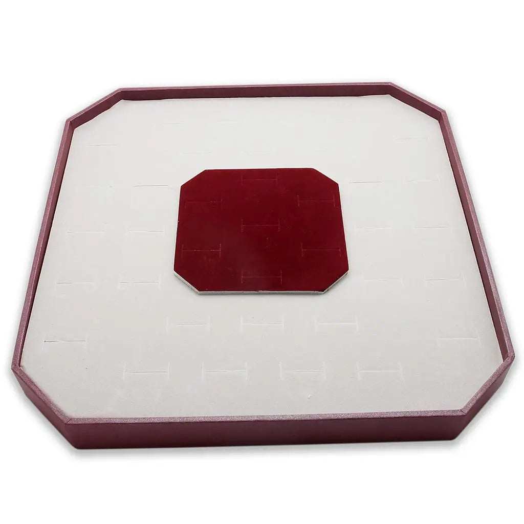 a red object sitting on top of a white surface