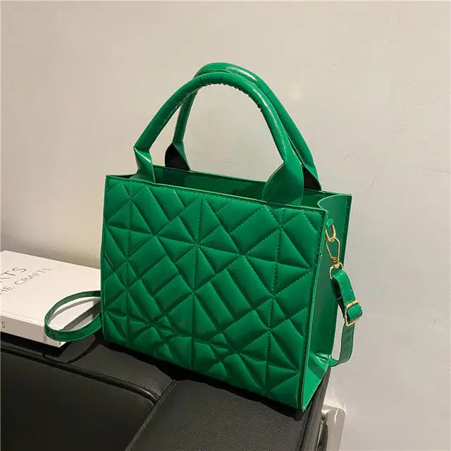 a green purse sitting on top of a table