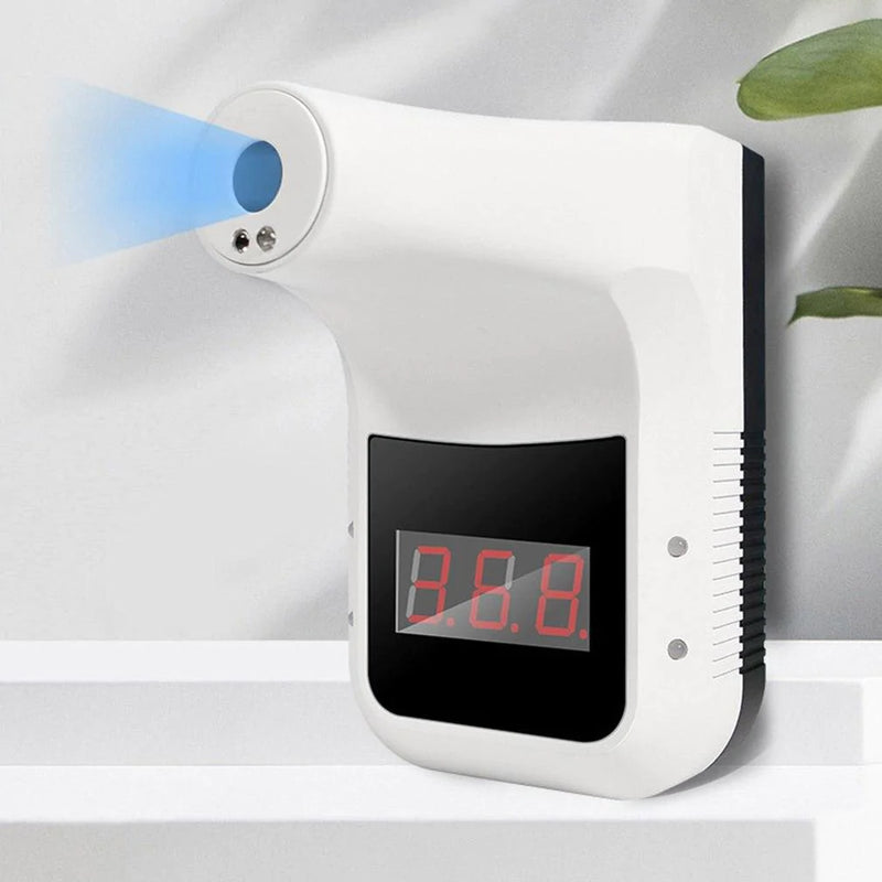 a digital alarm clock on a shelf next to a plant