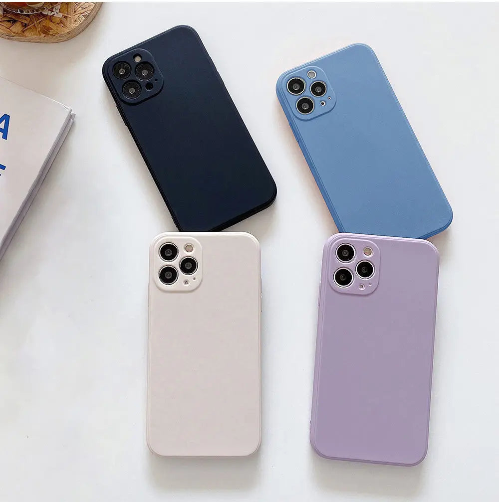 three different colors of cell phones sitting next to each other