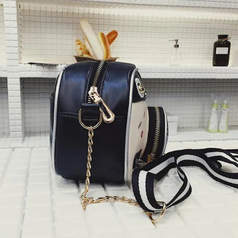 a black and white handbag sitting on top of a counter